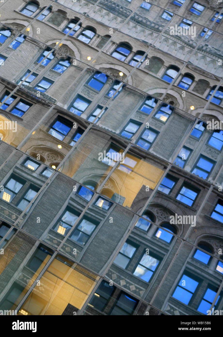 Full frame image of a manhattan office/apartment block reflected in glass frontage building across the street Stock Photo