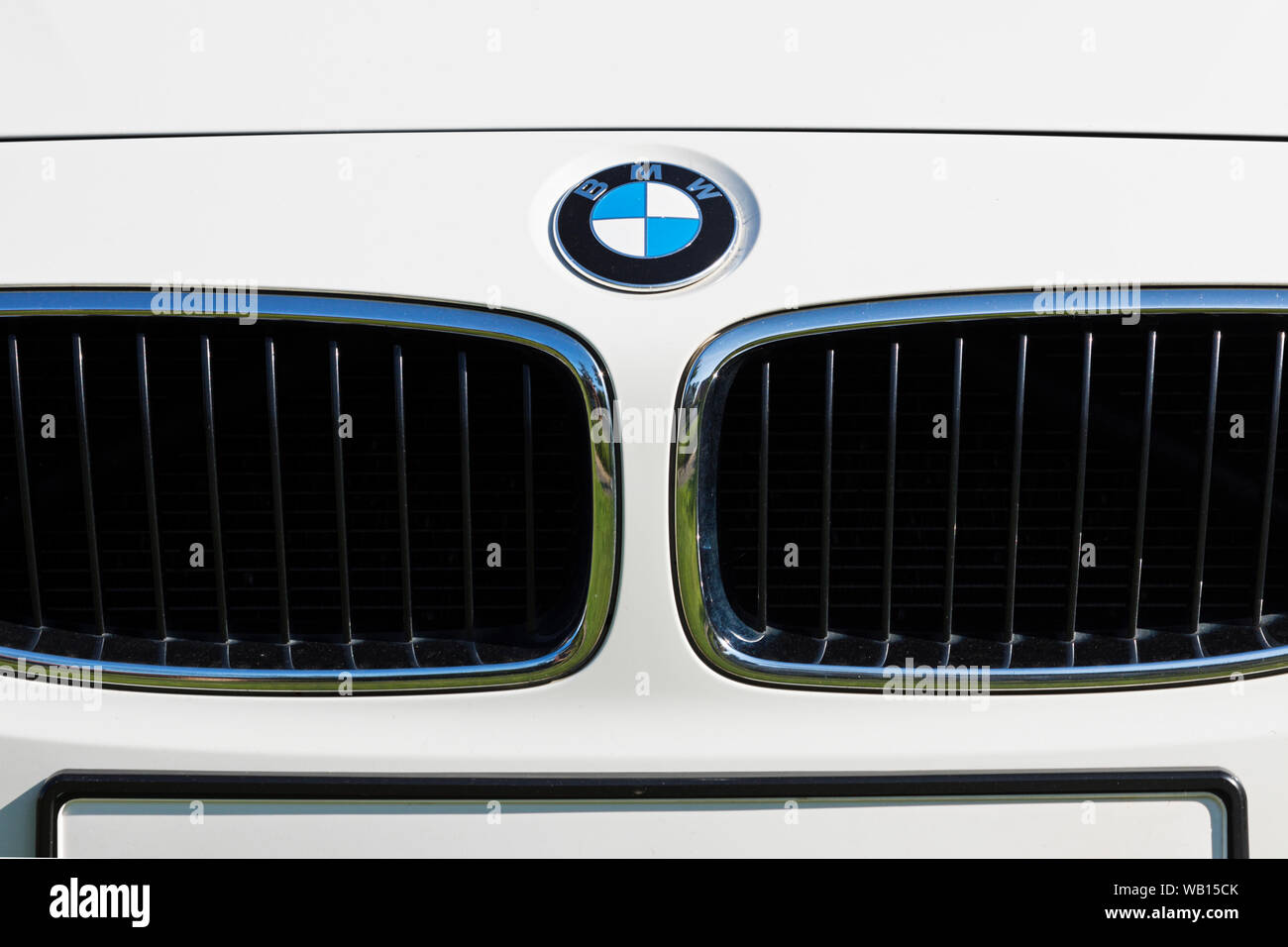 Stade, Germany - August 22, 2019: BMW logo above grill on front of white car. Stock Photo