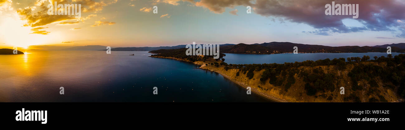 Greece, Aegean Sea, Pagasetic Gulf, Peninsula Pelion, Sound of Trikeri, Aerial view from Bay of Milina to Island Alatas with Holy Forty Monastery at sunset Stock Photo