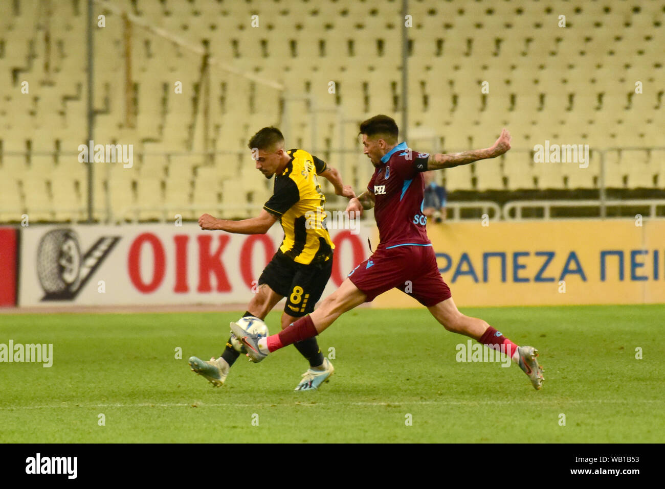 Sosa (no 8) of Trabzonspor tries to stop the effort of Simoes (no 8) of AEK  to pass the ball.AEK didn't make it, despite scoring in the 4 ', eventually  lost 3-1