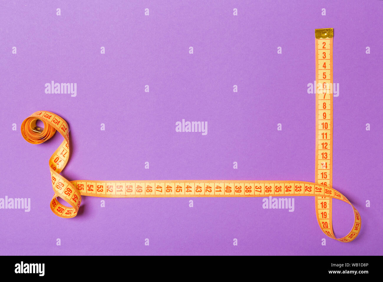 https://c8.alamy.com/comp/WB1D8P/top-view-of-border-frame-made-of-measure-tape-with-empty-space-for-your-idea-sewing-and-keeping-fit-concept-on-purple-background-WB1D8P.jpg