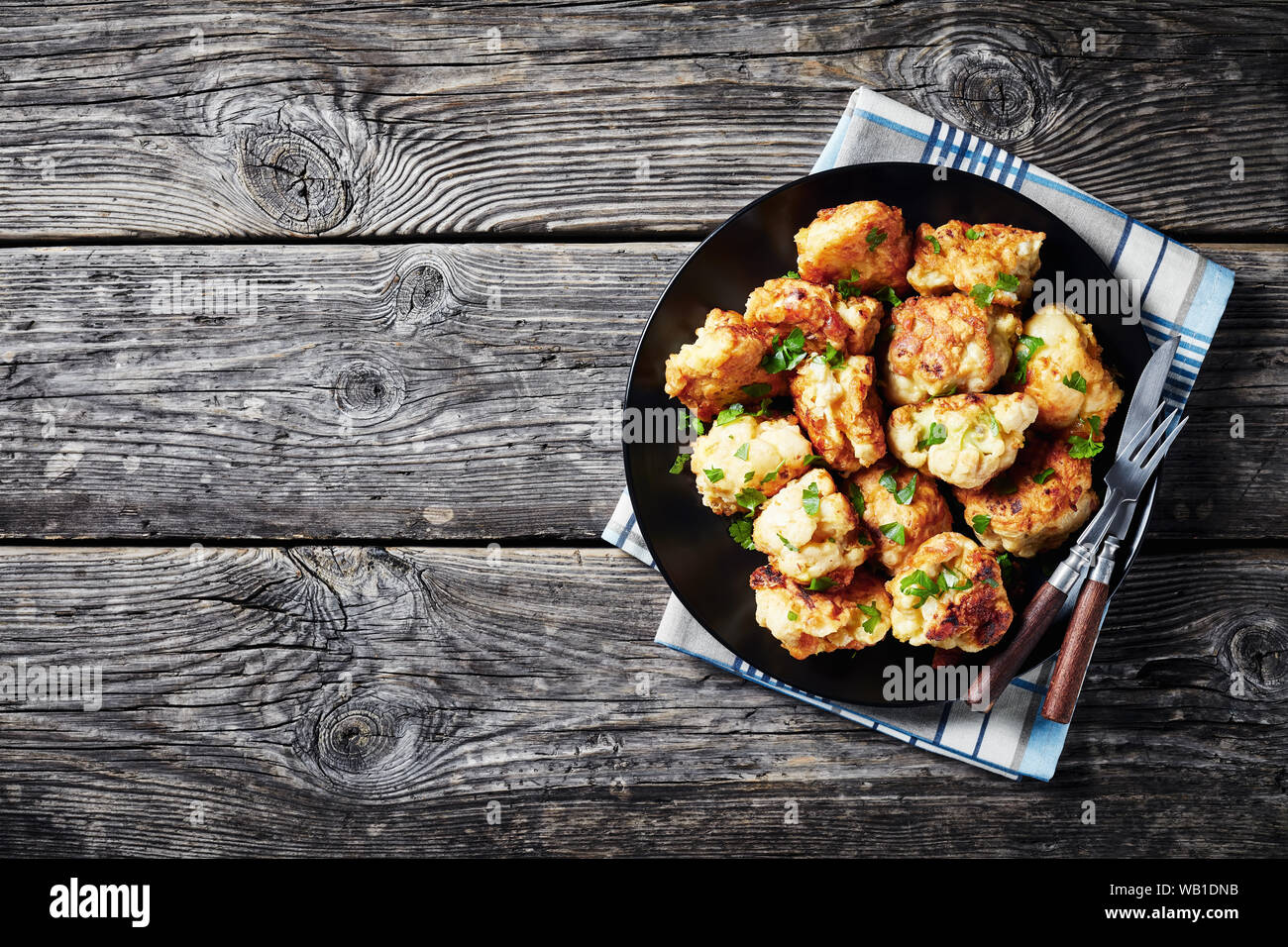 Moroccan tempurastyle Fried Cauliflower florets served on a black