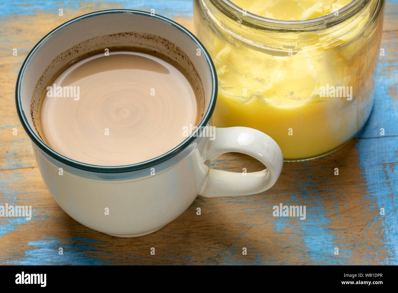 cup of fresh fatty coffee with ghee (clarified butter), MCT oil and cinnamon - ketogenic diet concept Stock Photo