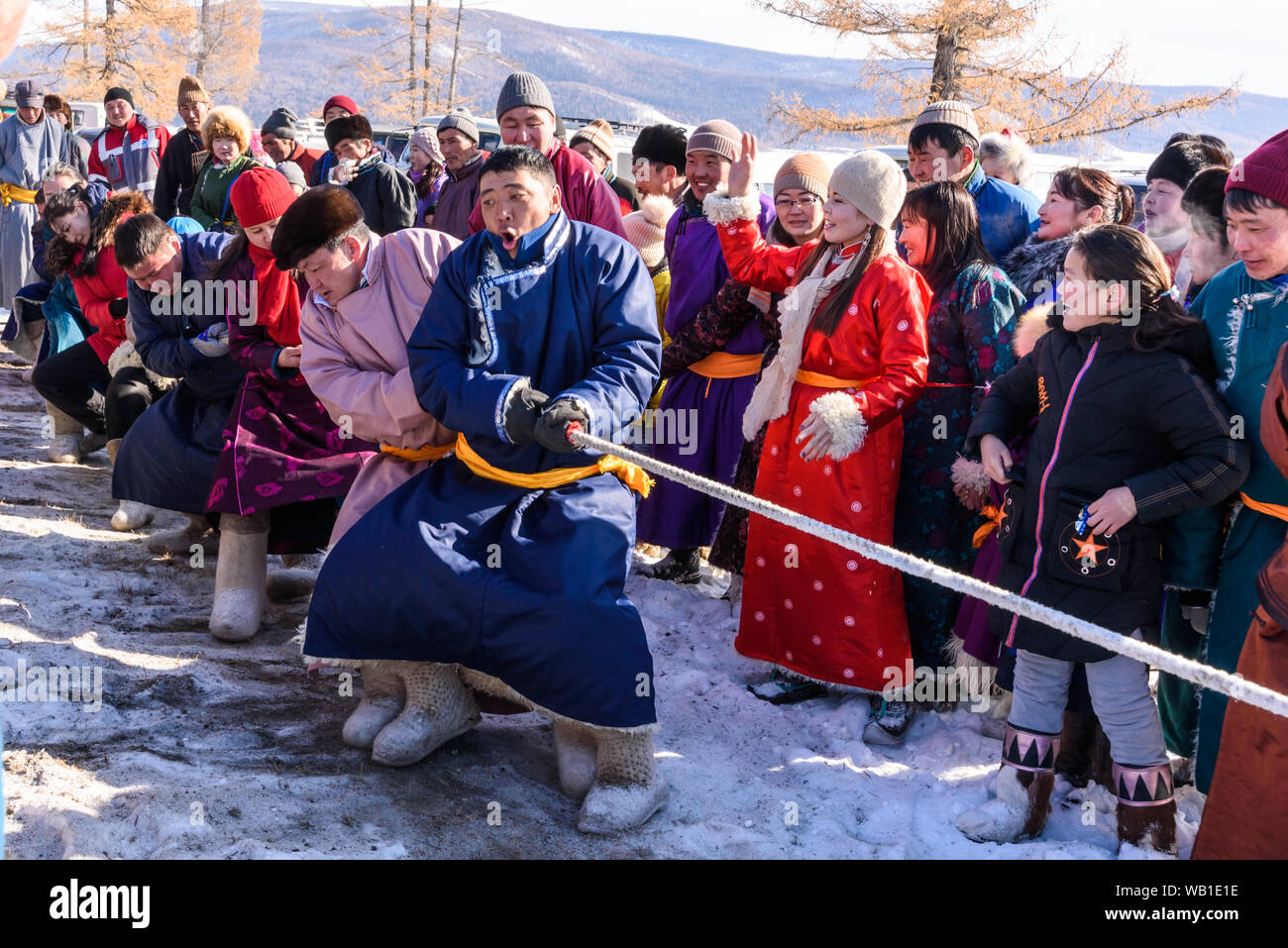 Hatgal, Mongolia, Febrary 25, 2018: Mongolian people compete in the tug-of-war in the winter games Stock Photo