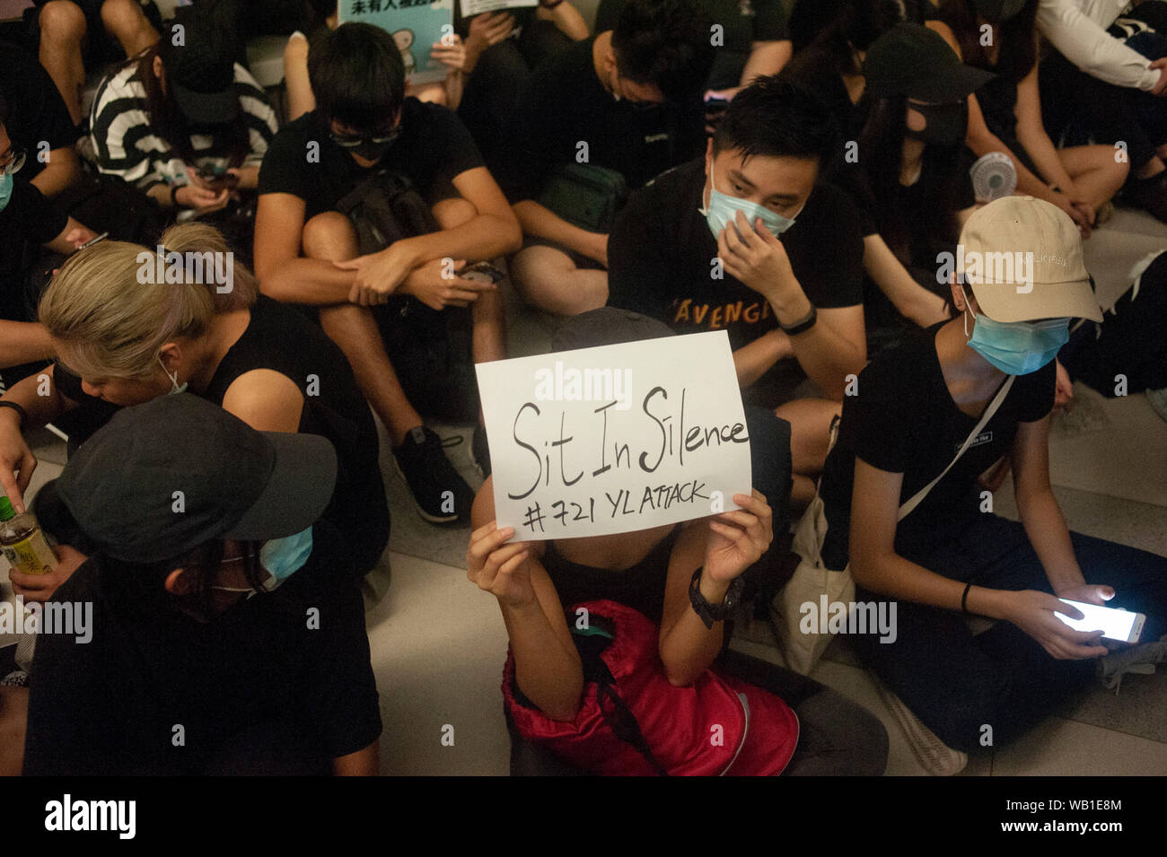 A protester holds a placard that says sit in silence during the ...