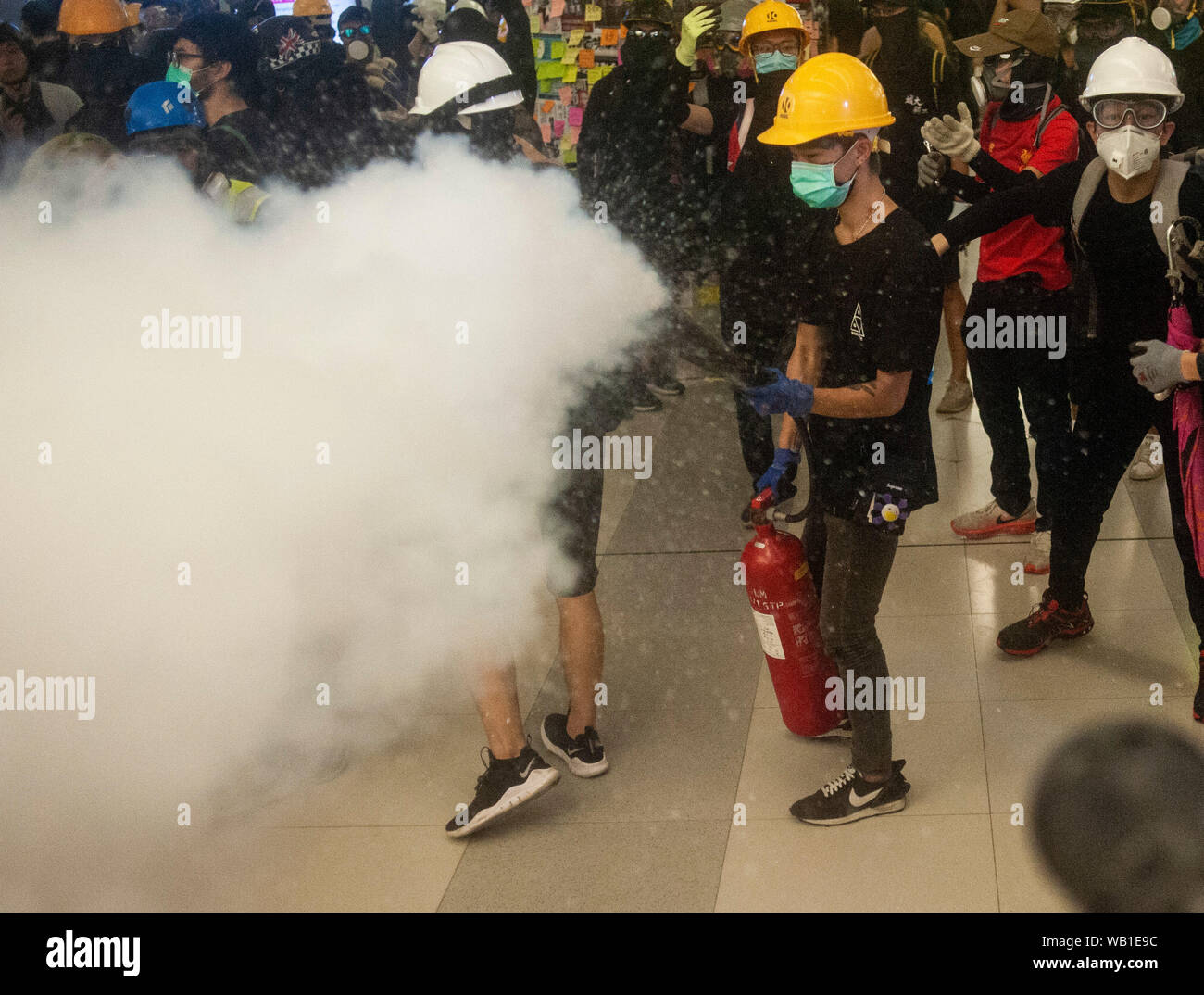 As police in riot gear closed in on the Yueng Long Metro station, pro-democracy protesters made barricades and doused the floor with water, soap, and oil in an attempt to dissuade the officers from advancing farther into the station during the demonstration.Thousands protesters gathered at the Yueng Long Metro Station and occupied the space in protest of the events that occurred one month ago when members of the Triad Gang assaulted protesters and journalists with iron rods and other weapons. Police in riot gear advanced on the protesters and attempted to disperse the crowd however they were r Stock Photo