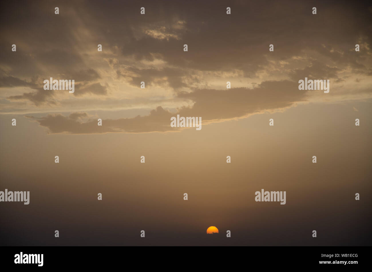 Colorful clouds on dramatic sunset sky Stock Photo - Alamy