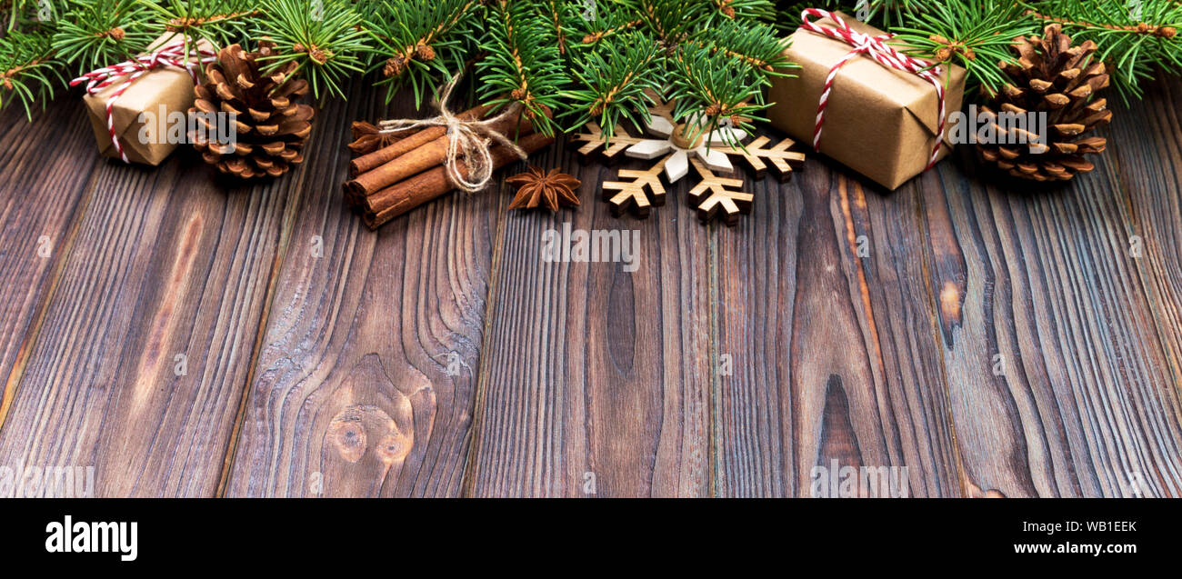 Christmas background with fir tree and gift box on banner wooden table ...