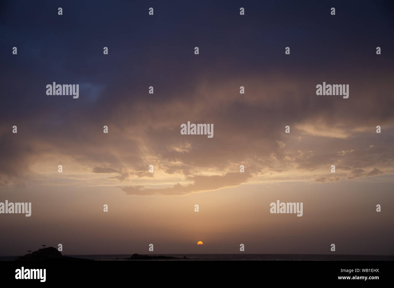 Colorful clouds on dramatic sunset sky Stock Photo - Alamy