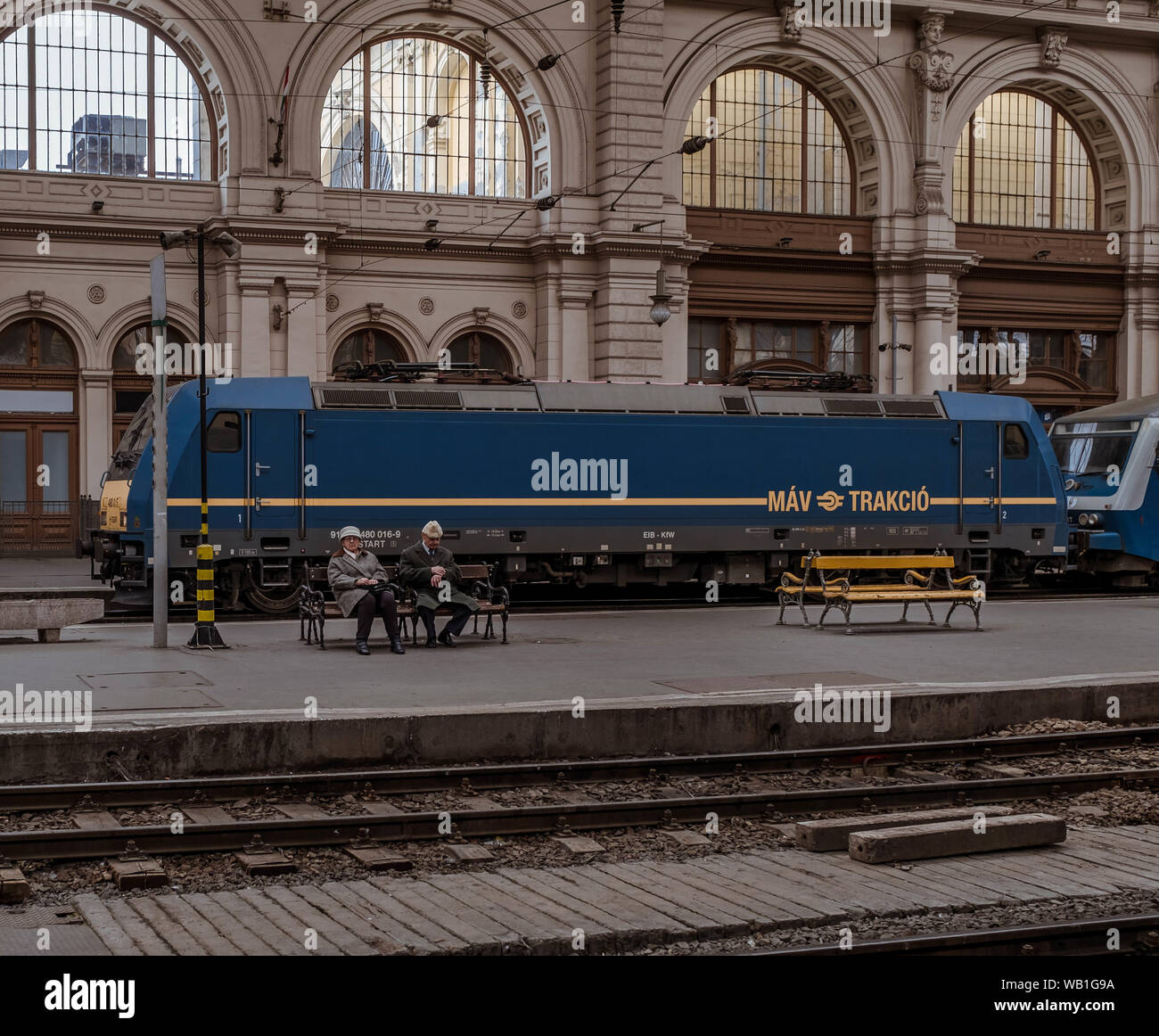 Elderly couple waiting for a train in Keleti train station in Budapest. Stock Photo