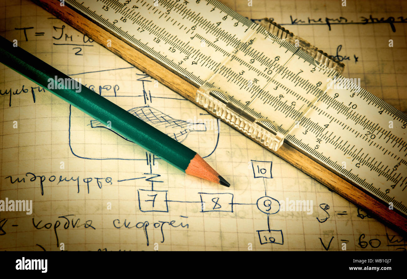 pencil and a slide rule on the old page with the calculations in ...