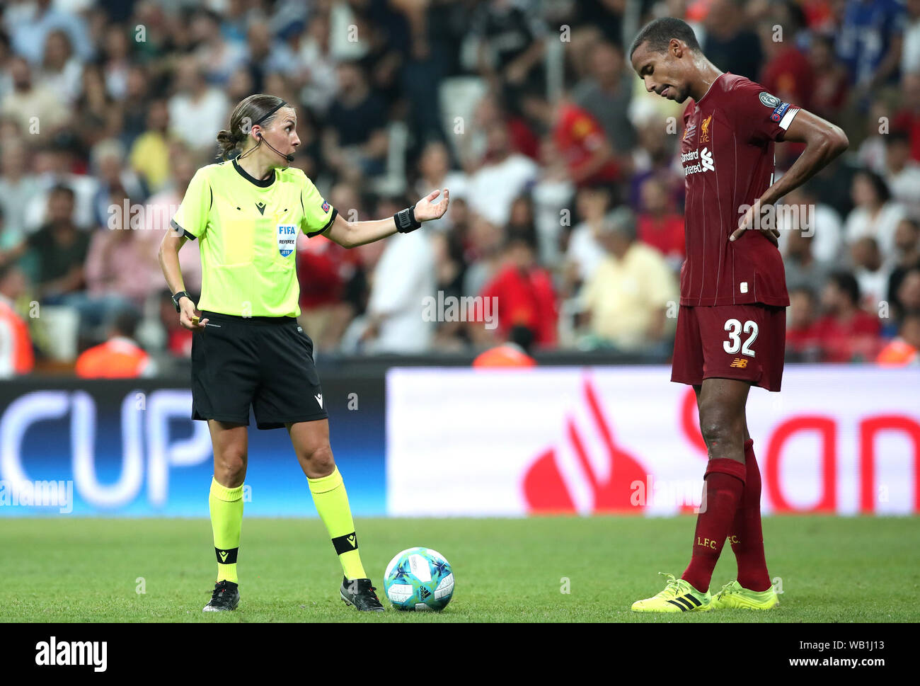Female Match referee Stephanie Frappart speaks with frustrated Liverpool's Joel Matip during the UEFA Super Cup Final at Besiktas Park, Istanbul Stock Photo