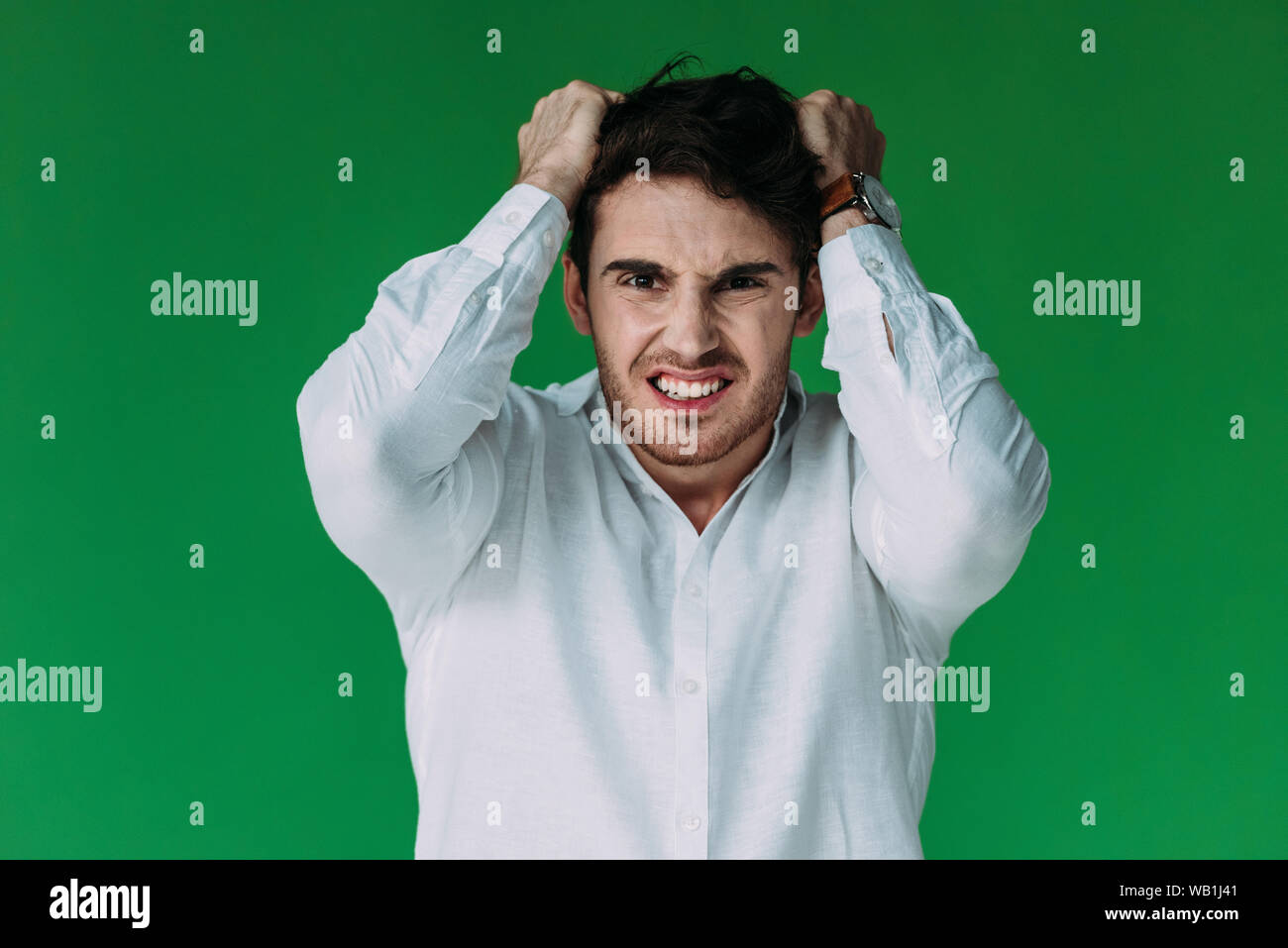 front view of angry man in white shirt looking at camera isolated on ...