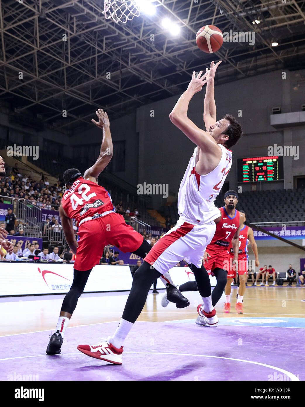 Suzhou, China's Jiangsu Province. 23rd Aug, 2019. Turkey's Sertac Sanli (front R) shoots the ball during a match against Puerto Rico at the 2019 Suzhou International Basketball Challenge and Culture Week in Suzhou, east China's Jiangsu Province, Aug. 23, 2019. Credit: Yang Lei/Xinhua/Alamy Live News Stock Photo