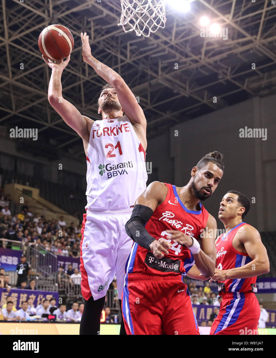 Suzhou, China's Jiangsu Province. 23rd Aug, 2019. Turkey's Sertac Sanli (L) shoots the ball during a match against Puerto Rico at the 2019 Suzhou International Basketball Challenge and Culture Week in Suzhou, east China's Jiangsu Province, Aug. 23, 2019. Credit: Yang Lei/Xinhua/Alamy Live News Stock Photo