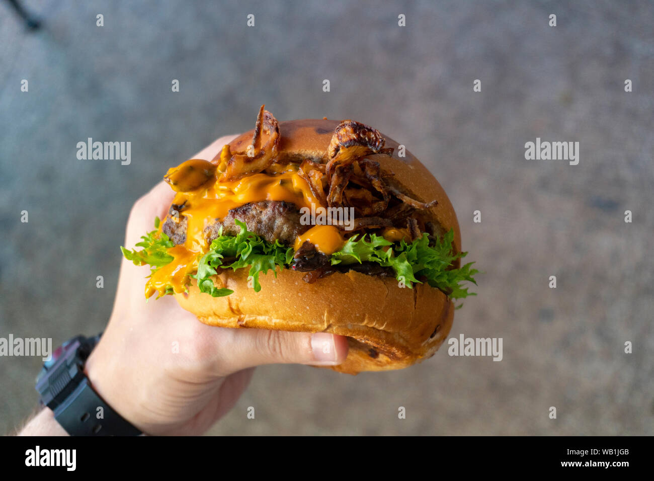 a hand holding hamburger top view Stock Photo