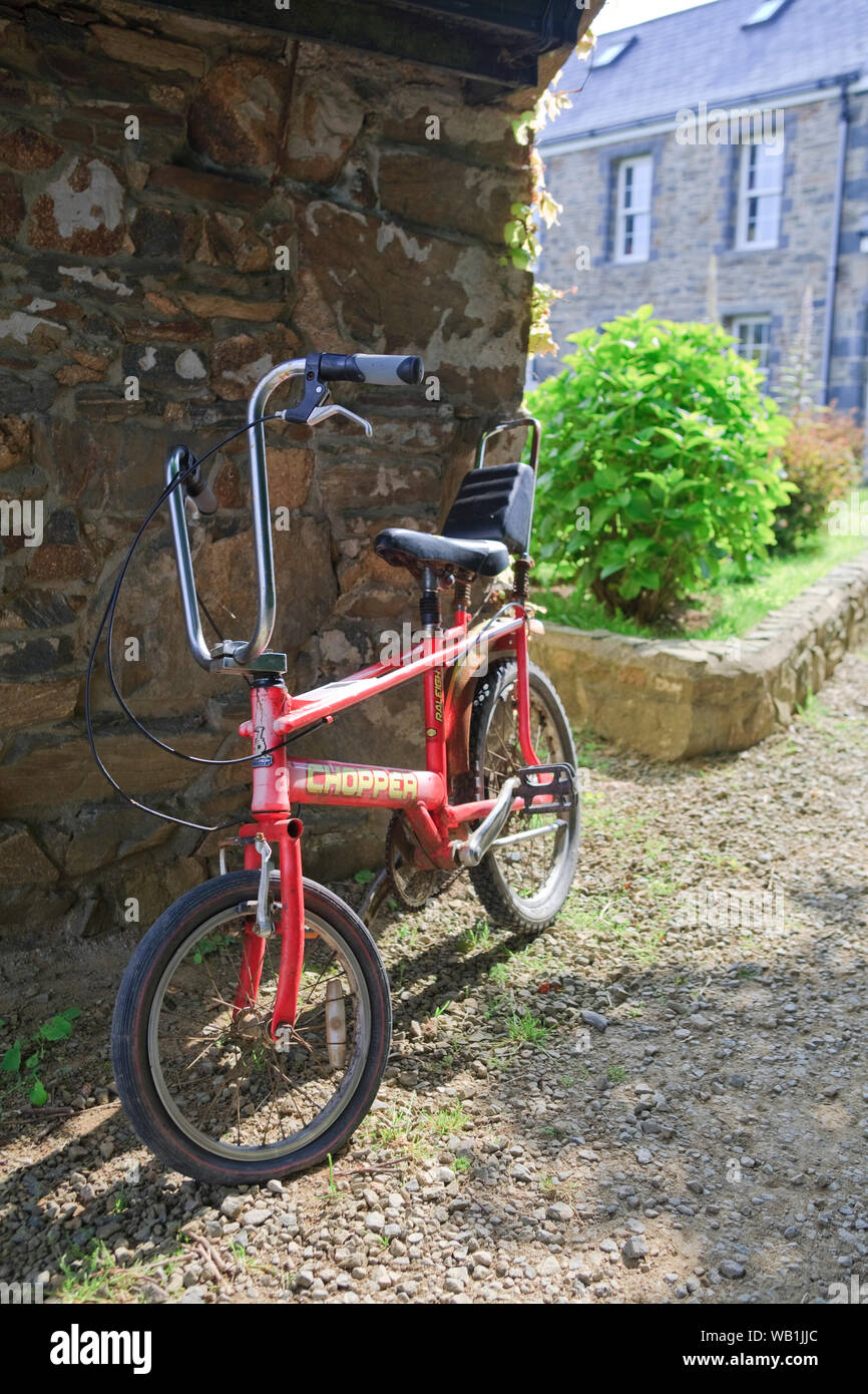 A retro chopper bicycle outside a farmhouse on the island of Sark in the Channel Islands, UK Stock Photo