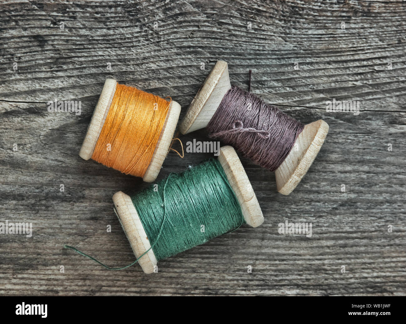 Still Life Of Spools Of Thread On A Wooden Background Stock Photo
