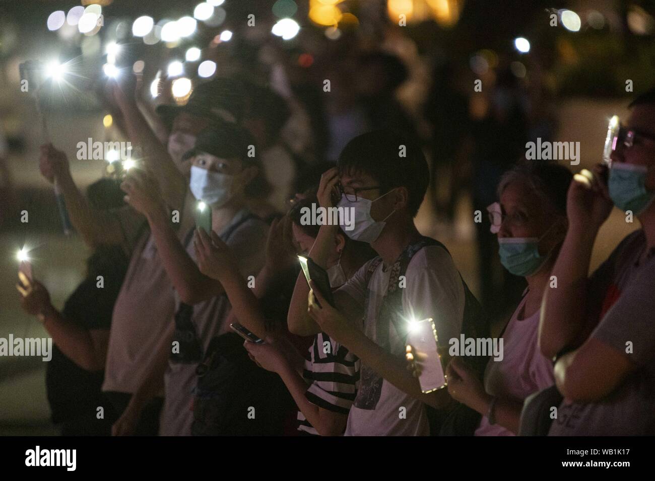 Tsim Sha Tsui, Hong Kong S.A.R. 23rd Aug, 2019. Thousands of protesters create the Hong Kong Human Chain along Hong Kong's Avenue of the Stars on the Victoria Harbor waterfront on the 30th annivesary of the Balkan Human Chain as part of the ongoing pro democracy anti elab protest movement. Credit: Adryel Talamantes/ZUMA Wire/Alamy Live News Stock Photo