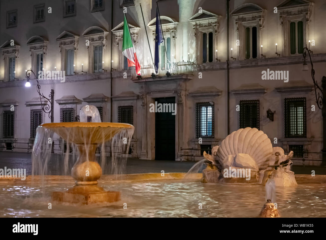 Rome, Italy - August 18, 2019: Palazzo Chigi, institutional seat of the Italian government. The main entrance with the building facade and flags. Stock Photo