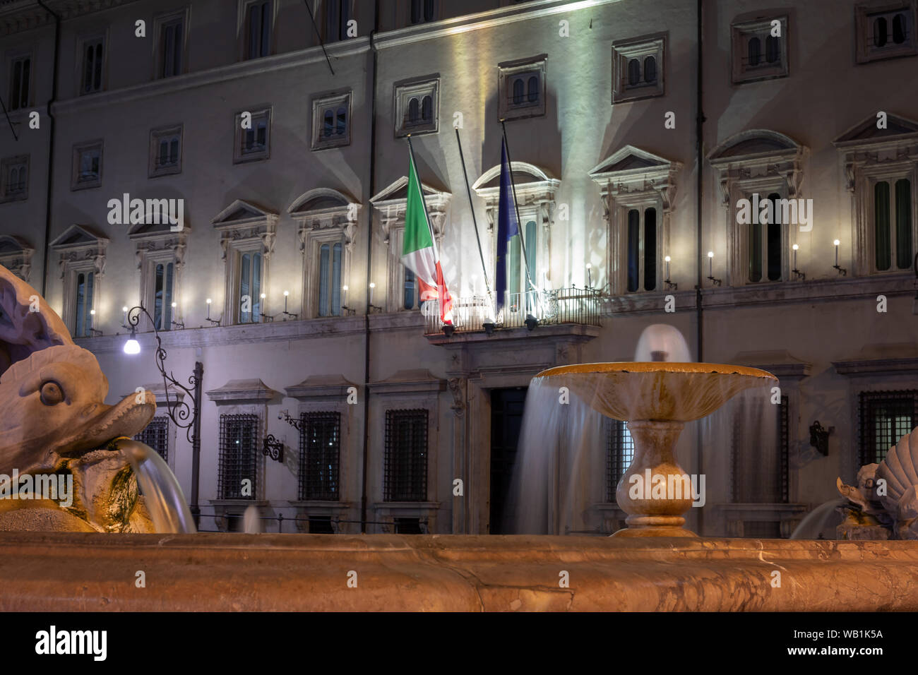Rome, Italy - August 18, 2019: Palazzo Chigi, institutional seat of the Italian government. The main entrance with the building facade and flags. Stock Photo