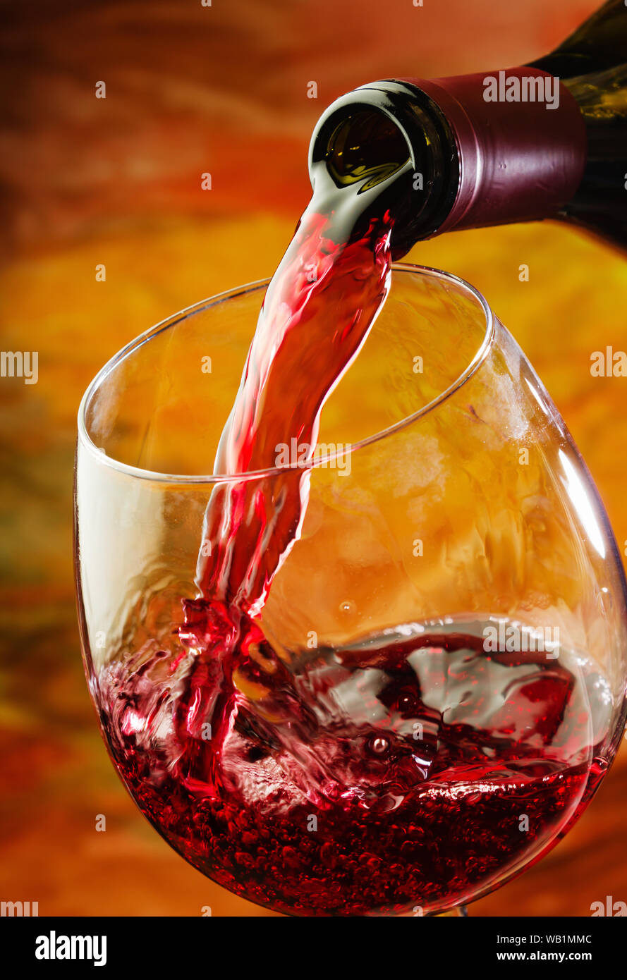 Red wine being poured into wine glass Stock Photo Alamy