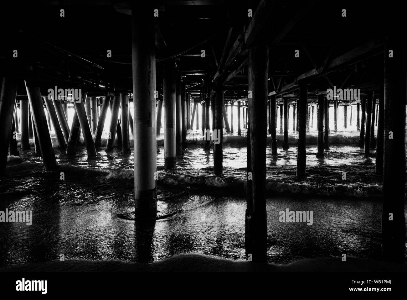 Black and white iew of the pylons of Santa Monica pier in Los Angeles USA Stock Photo