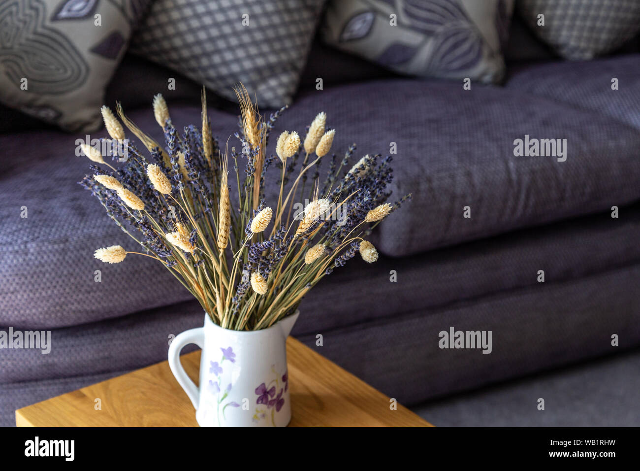 Dried lavender and dried grasses in a jug in a modern setting. Stock Photo
