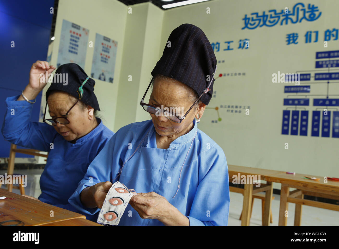 Danzhai, China. 23rd Aug, 2019. Craftswomen of Miao ethnic group make Miao embroidery at a Miao handicraft cooperative of 'Mom Handworks' in Taijiang County, southwest China's Guizhou Province, Aug. 22, 2019. A handicraft cooperative and a batik craft cooperative of 'Mom Handworks', a public welfare project initiated by China Women's Development Foundation (CWDF), were put into operation in Guizhou's Taijiang and Danzhai respectively. Credit: Xinhua/Alamy Live News Stock Photo