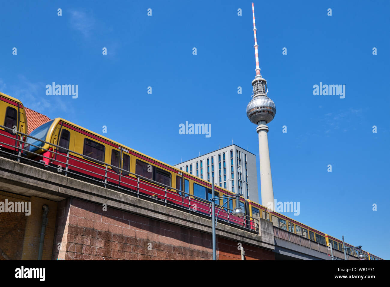 Moving commuter train and the famous Television Tower in Berlin Stock Photo