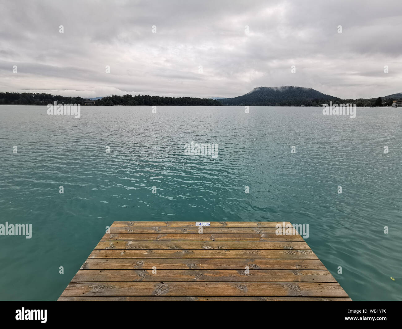 Tranquil green lake with pier, Faaker See, Austria, Europe Stock Photo