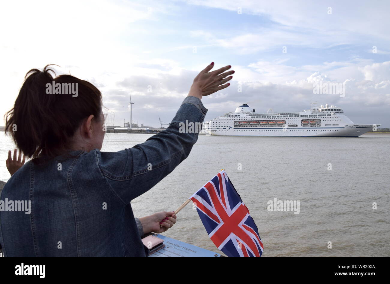 Columbus is a large luxury cruise ship. Onlookers wave goodbye, as she sails from London International Cruise Terminal, Tilbury. Stock Photo