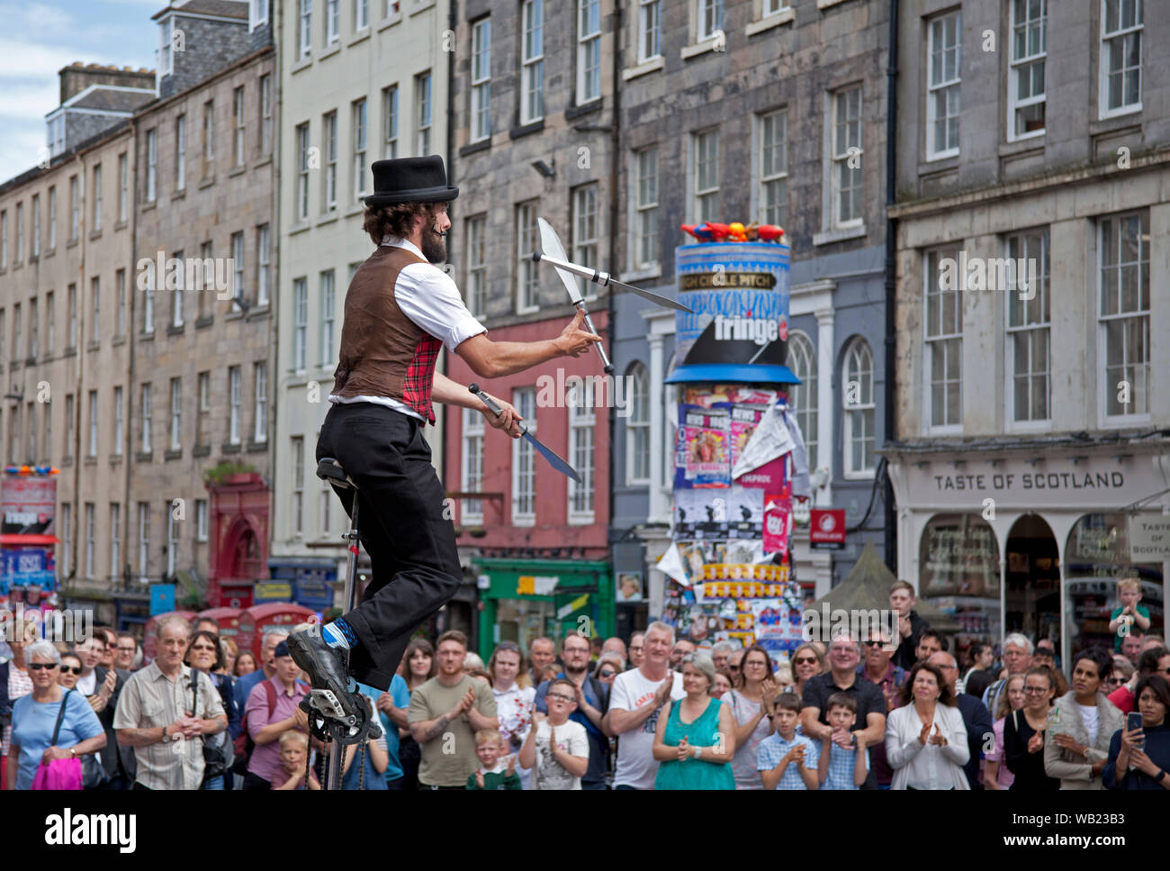 Royal Mile, Edinburgh, Scotland, UK. 23rd August 2019. Street Performer Patrick juggler and unicycle rider entertains the audience on the High Street. Stock Photo