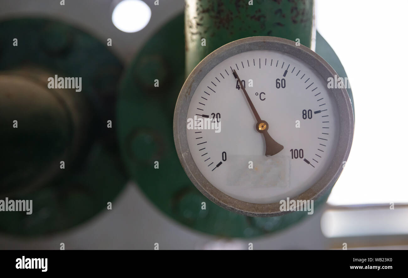 https://c8.alamy.com/comp/WB23K0/industrial-thermometer-temperature-gauge-control-celsius-scale-old-dial-blur-industrial-background-WB23K0.jpg