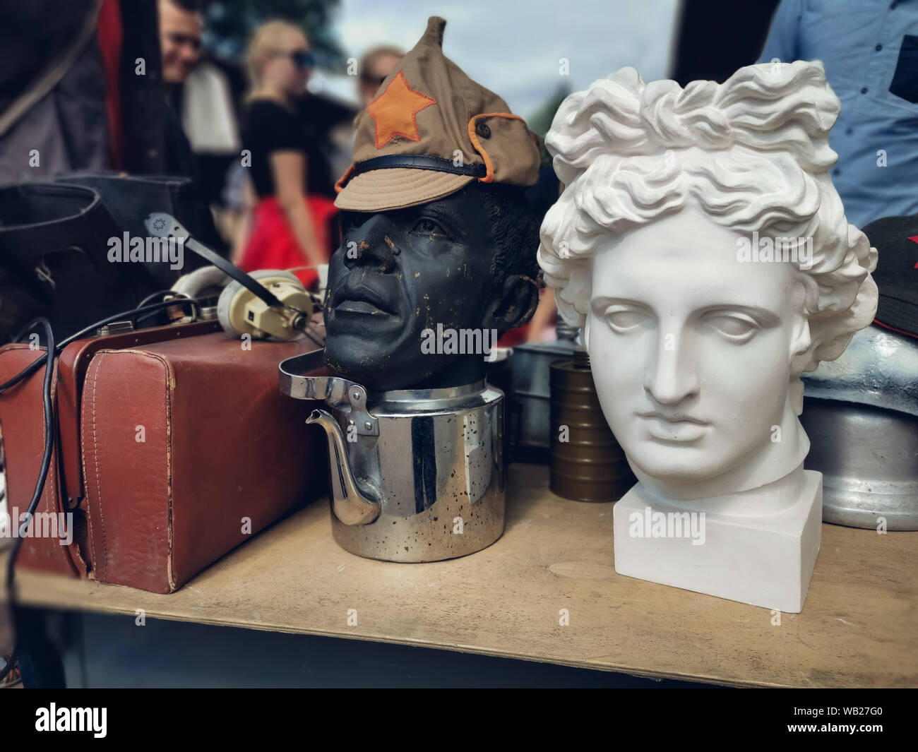 Saint-Petersburg, Russia - 22 July 2019: cap Soviet times revolution on a mannequin, and plaster head of Apollo at the Flea market. Stock Photo