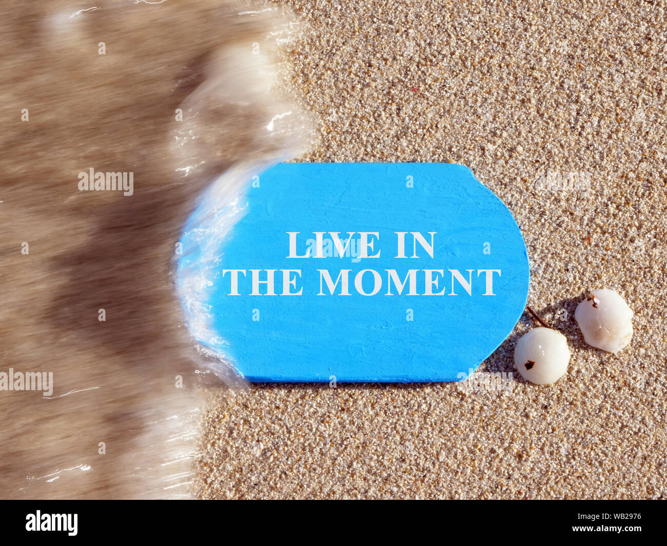 Live in the Moment sign on a blue plate. Stock Photo