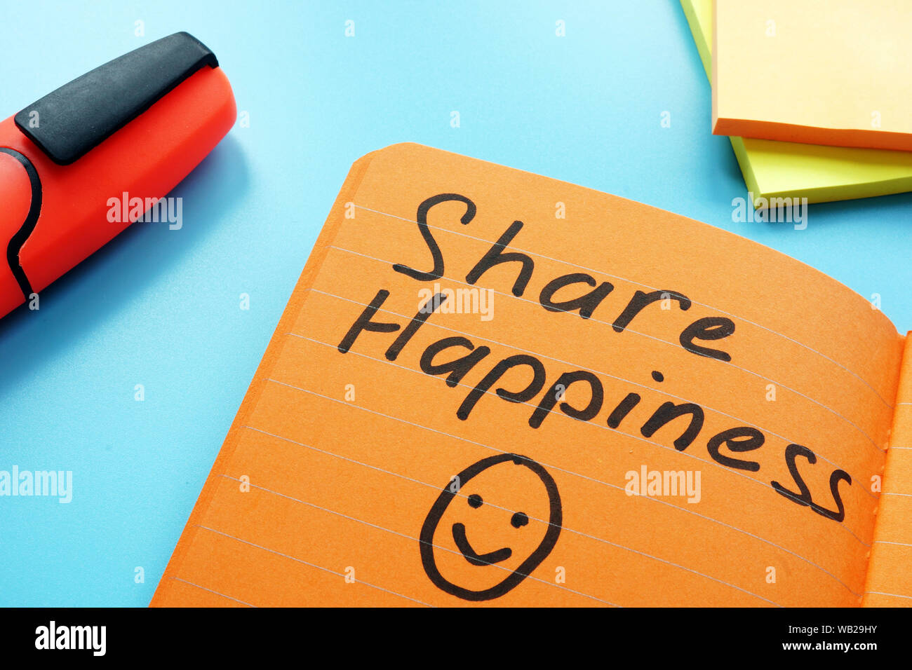 Share happiness sign as inspiration quote in the note. Stock Photo