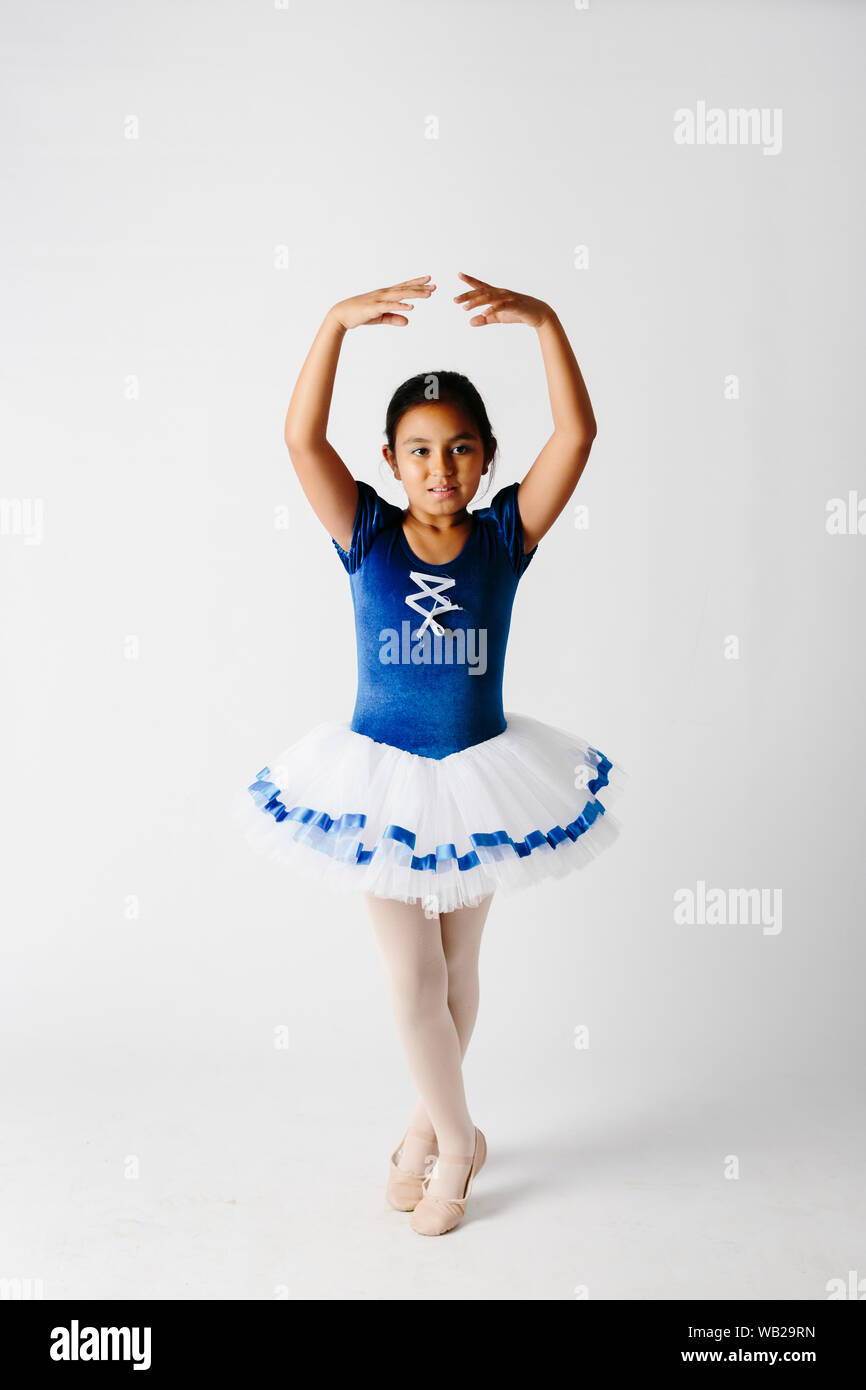 A 9 Year Old Girl Dressed On Her Ballerina Outfit She Has Hispanic Ethnicity Features She Stands On Her Ballet Pose She S Looking At Camera Stock Photo Alamy