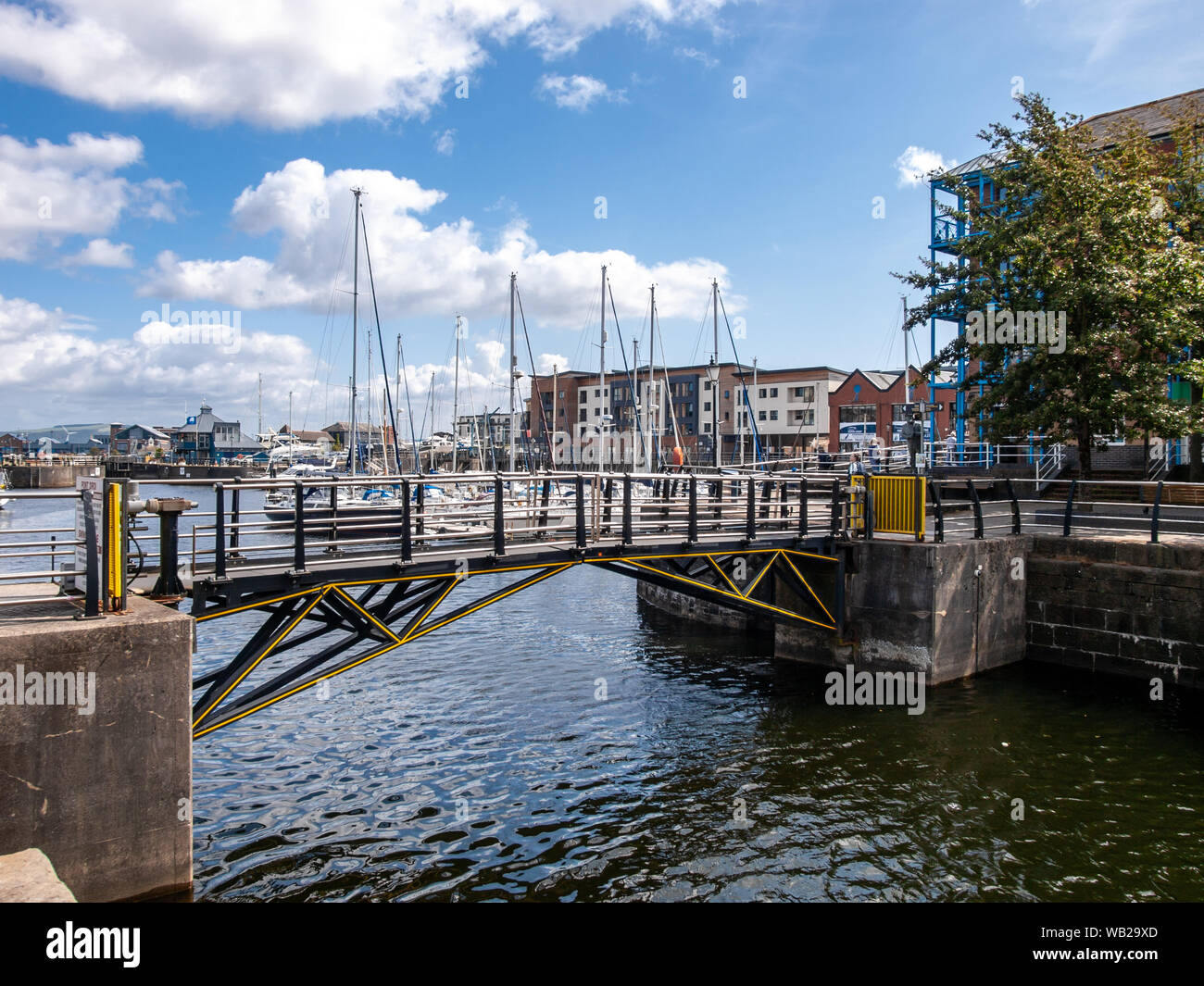 Swansea Marina pedestrian swing bridge with boats and yachts off to the east. Swansea, Wales, UK. Stock Photo