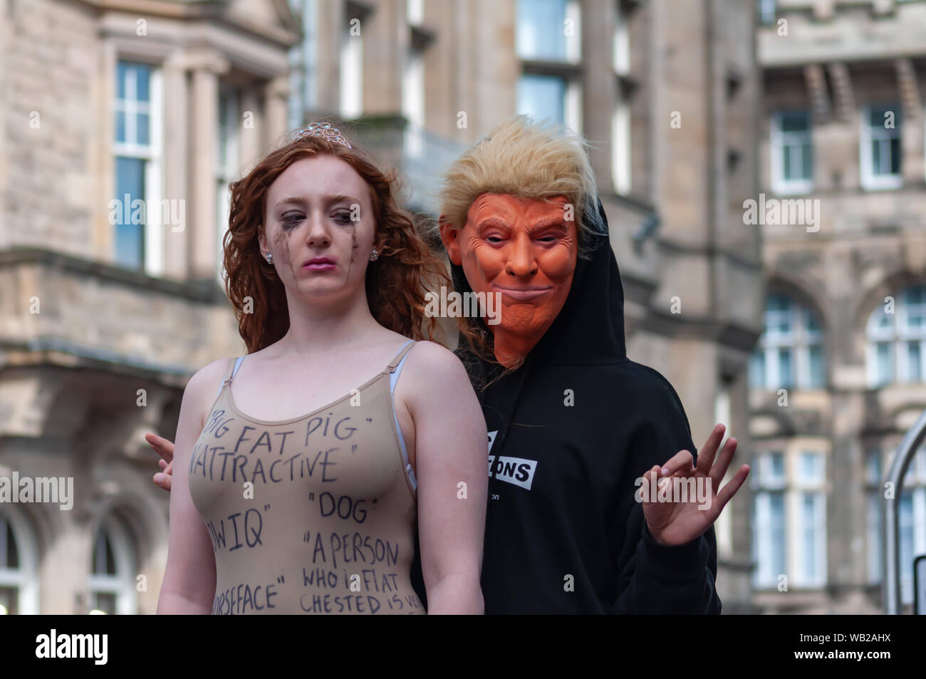 Edinburgh, Scotland, UK. 23rd August, 2019. Performers on The Royal Mile promoting the show Beauty Is Pain at Paradise In The Vault venue 29 during the Edinburgh Fringe Festival. Beauty is Pain is a political performance art piece surrounding US President Donald Trump's support of the Miss USA pageants and treatment of women in the mainstream media. Credit: Skully/Alamy Live News Stock Photo