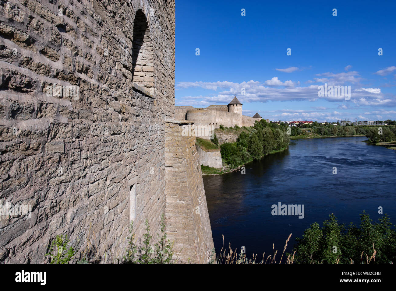 The medieval German castle in Estonia and the Russian fortress Ivangorod are separated by the Narva River. The bridge between them forms the border of Stock Photo