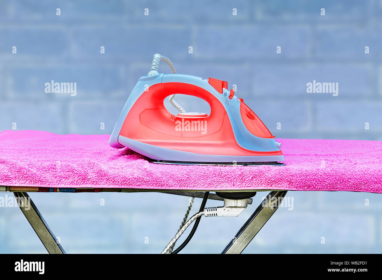 An ironing board with a power point is located in the living room. On