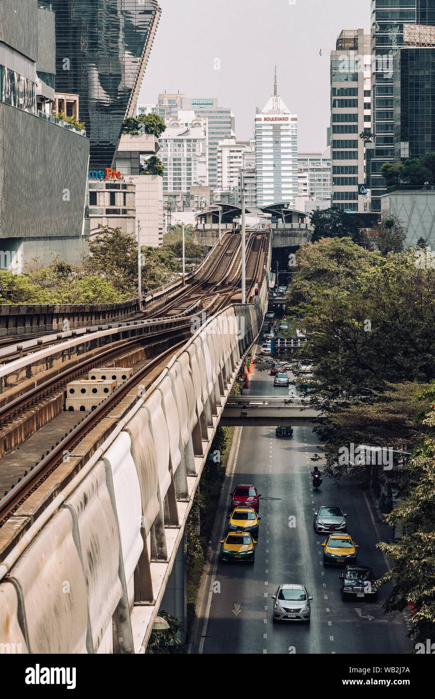 BTS skytrain is running over the busy road in Bangkok, Thailand Stock Photo