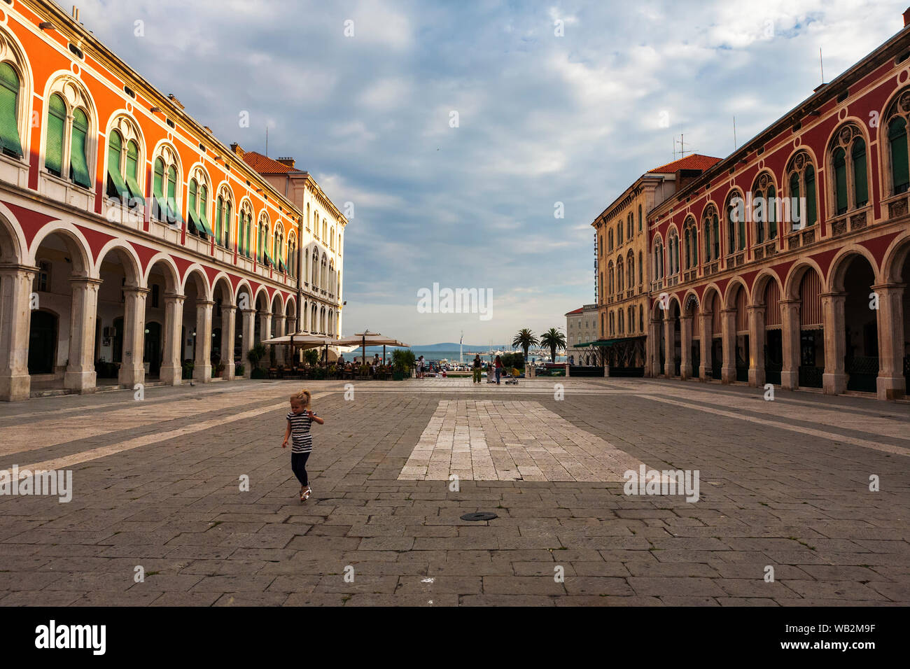 A single child plays in the grand Trg Republike, popularly known as Prokurative, Split, Croatia Stock Photo