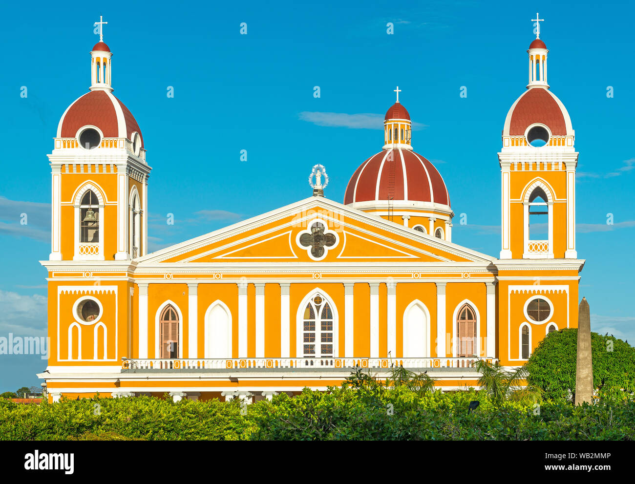 The facade of the neo-classical cathedral in yellow and orange tones at sunset in Granada, Nicaragua, Central America. Stock Photo