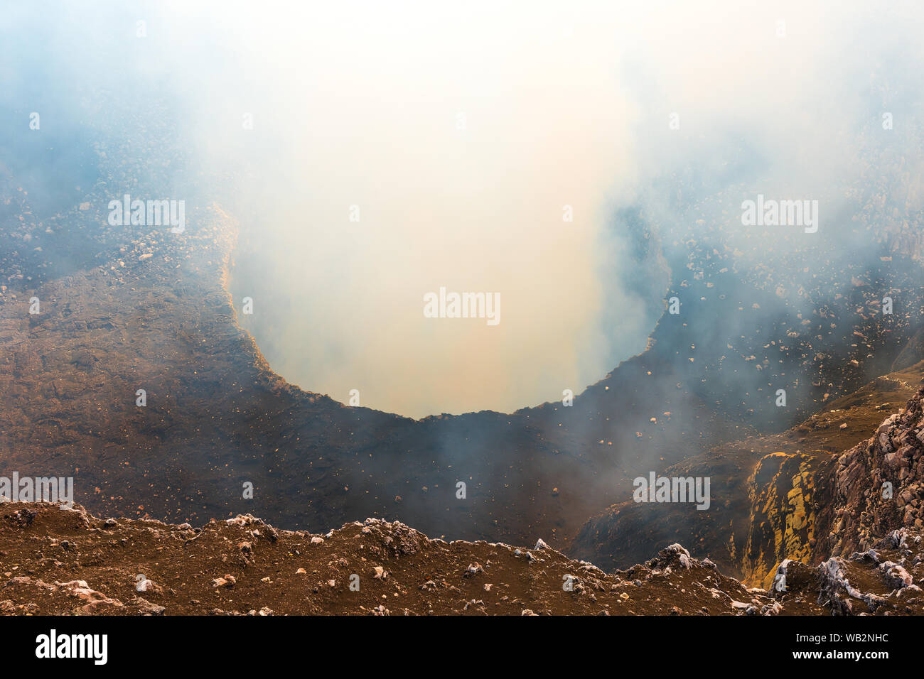 The active volcanic crater of the Masaya volcano with its gas emissions (sulfur dioxide) at sunset located between Managua and Granada, Nicaragua. Stock Photo
