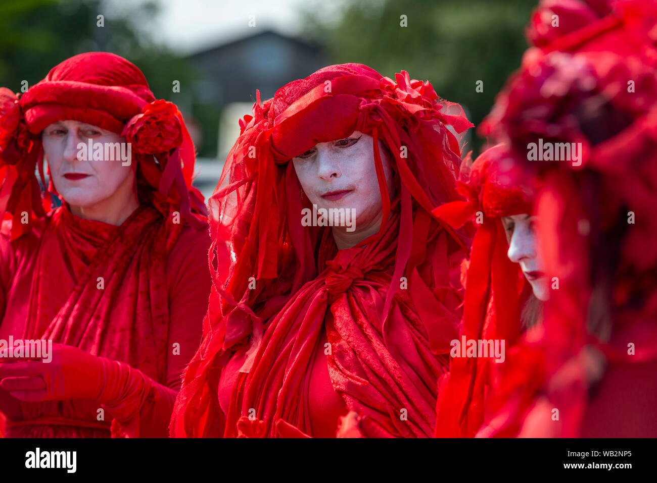 Royal Cornwall Hospital, Truro, Cornwall. Performance protest troupe the Red Rebels wait for Boris Johnson outside the hospital after a surprise visit Stock Photo