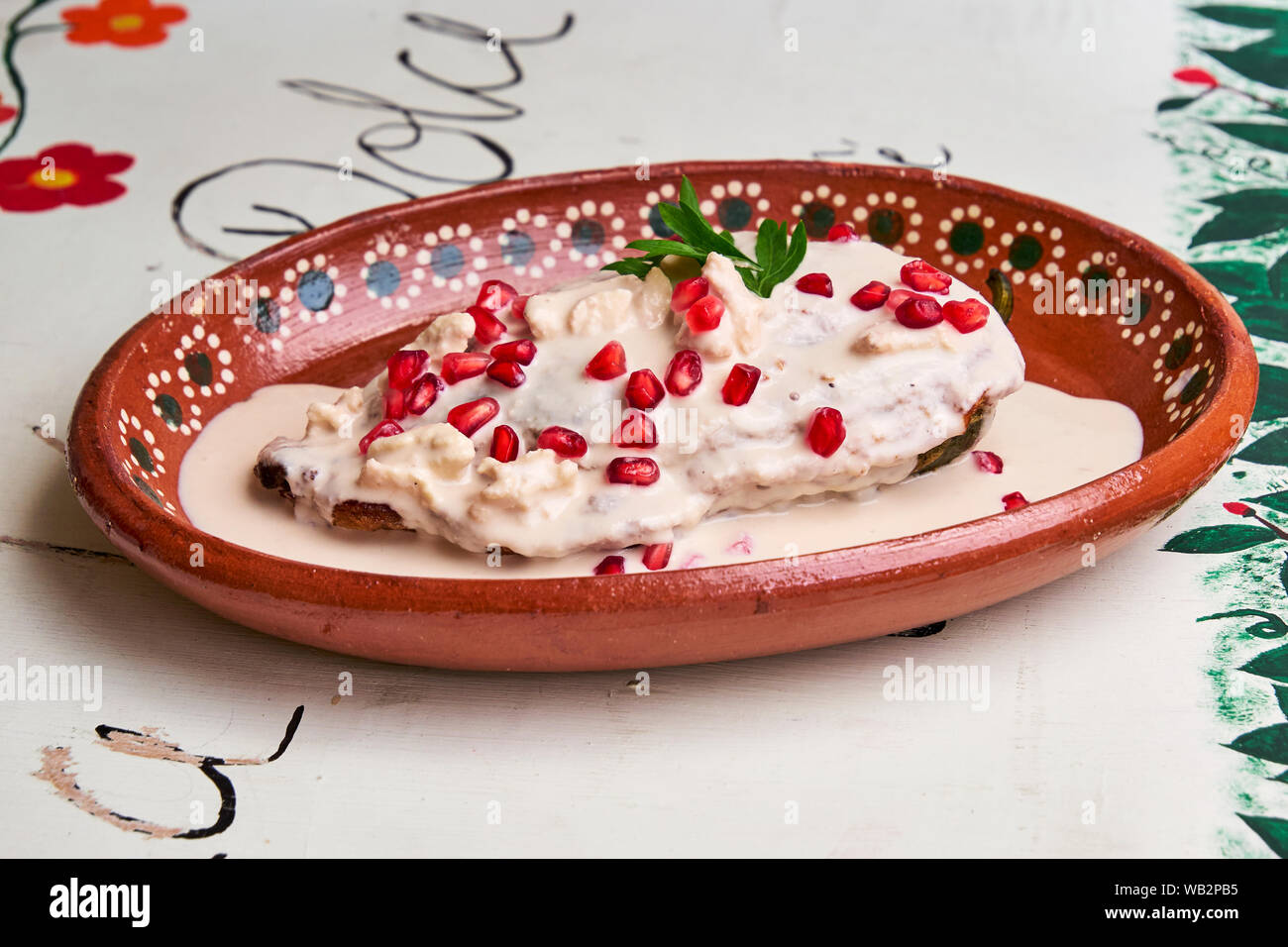 Chile en Nogada, a traditional dish from Puebla with the addition of walnut cream, pomegranate seeds and parsley. Stock Photo