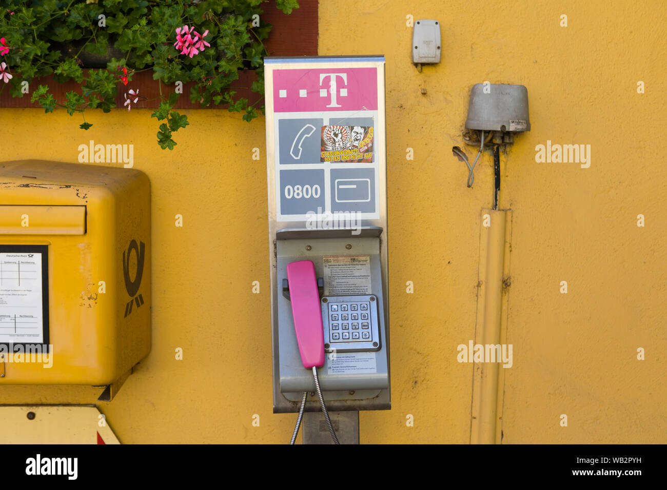 Old fashioned public telephone at the inner city post office, Nierstein Germany Stock Photo