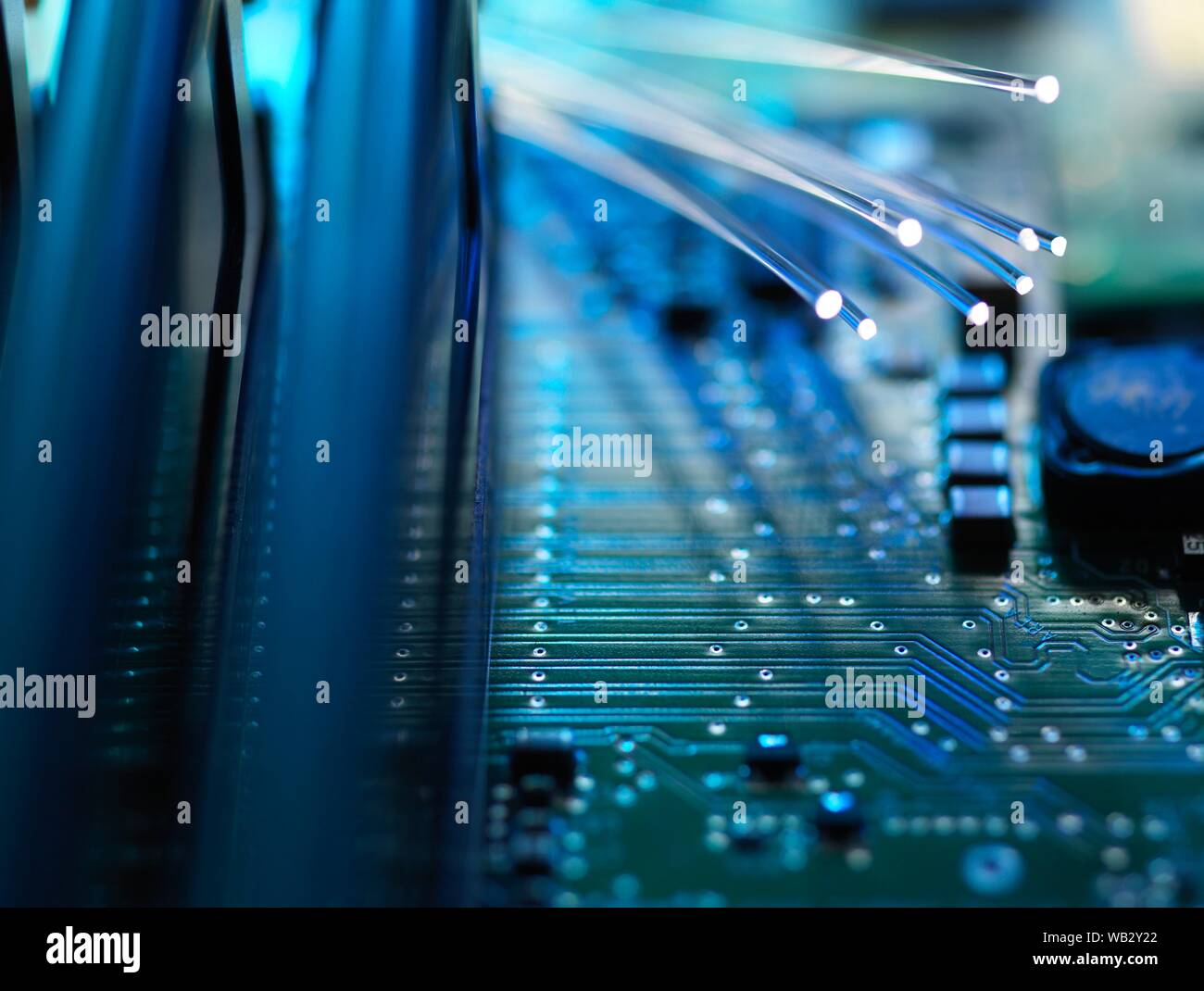 Digital communication, conceptual image. Fibre optics carrying data passing across a computer's motherboard. Stock Photo